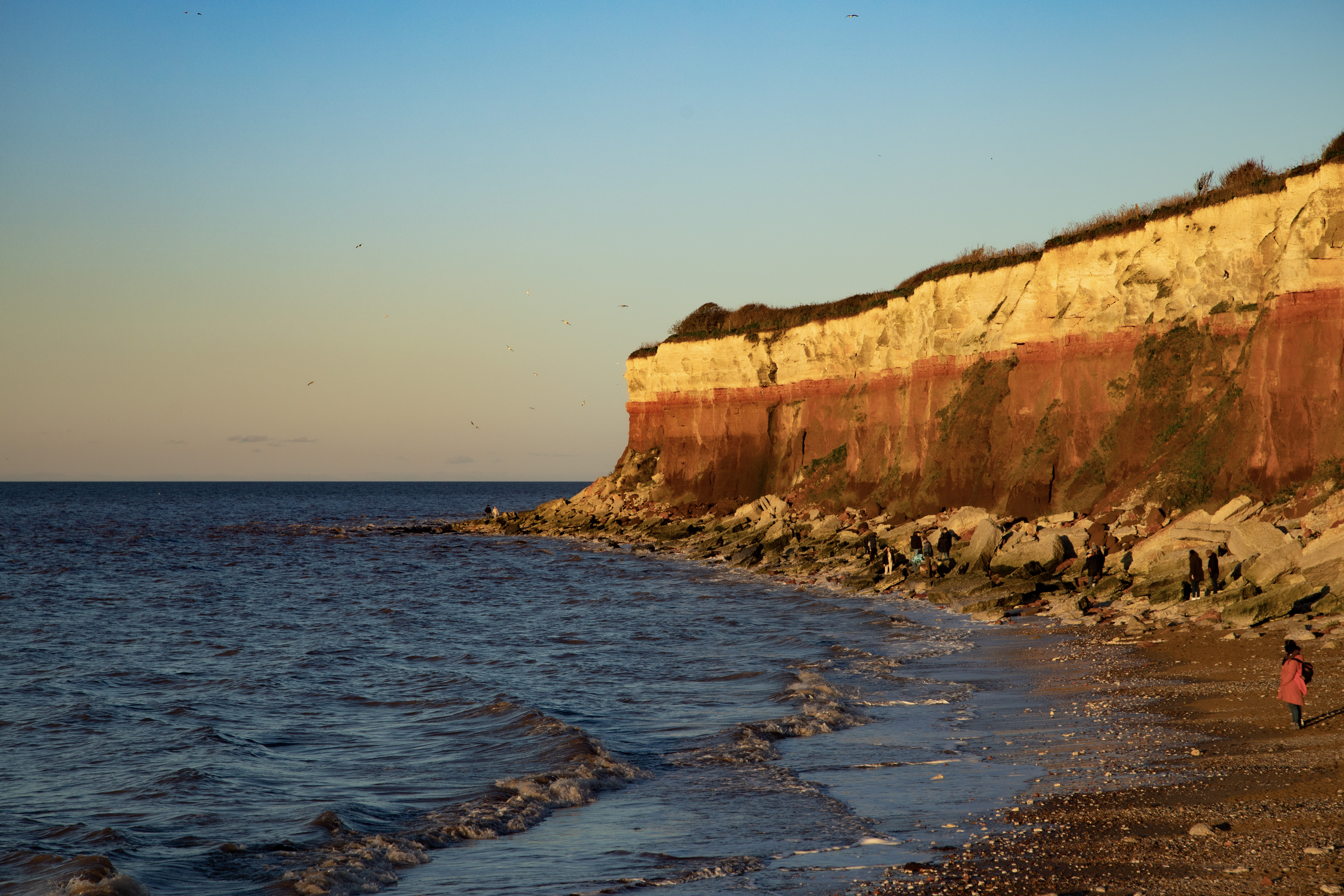 Campervan parked on the grass near Hunstanton beach at dusk, Norfolk, UK